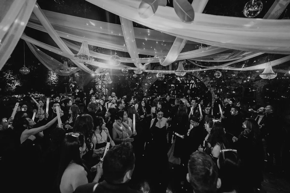 Guests dancing and celebrating at a wedding party at night