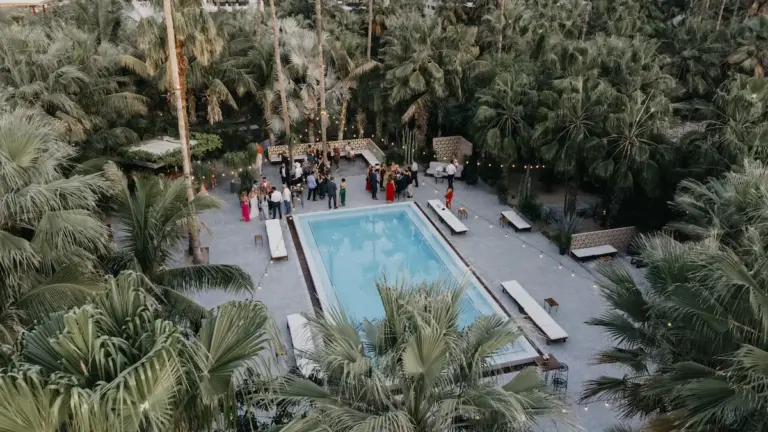 Wedding ceremony among the palm trees at Acre Resort, Los Cabos