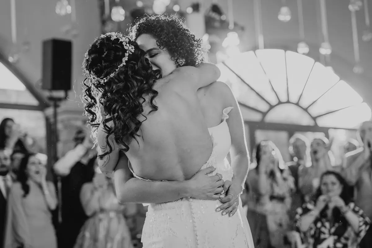 The two brides embracing during their first dance at the reception at Hacienda Los Arcángeles