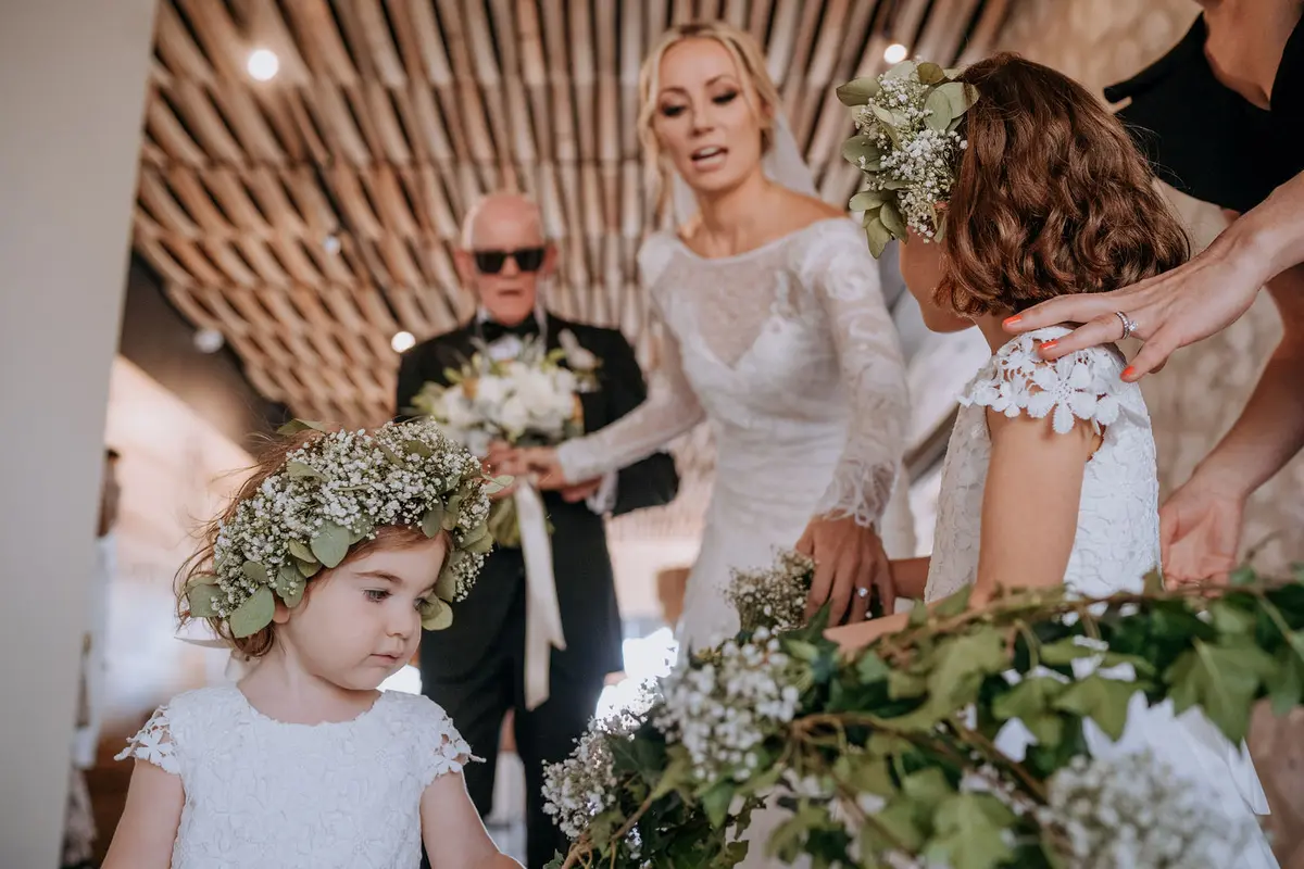 Bride walking down the aisle with her father under the traditional lazo at Viñedo San Francisco