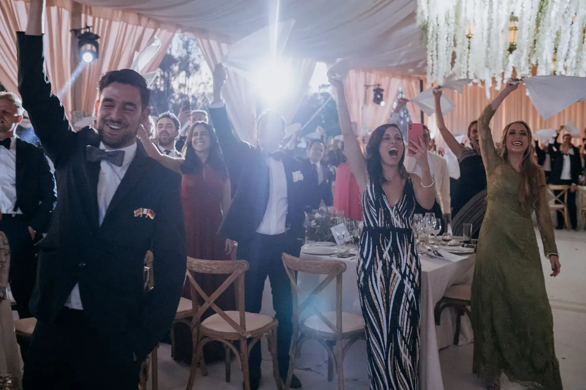Wedding reception under the tent with hanging amaranth at Viñedo San Francisco
