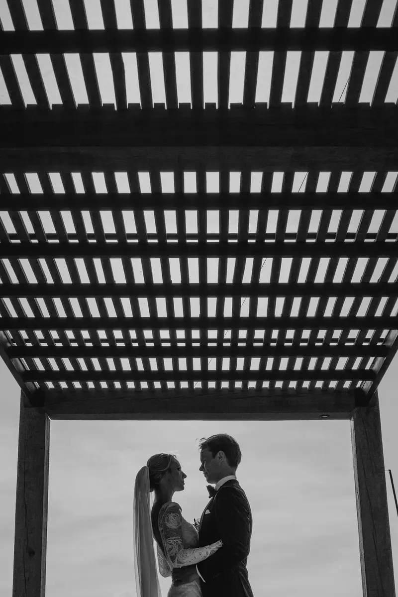 Bride and groom silhouetted under the pergola corridor at Viñedo San Francisco, San Miguel de Allende