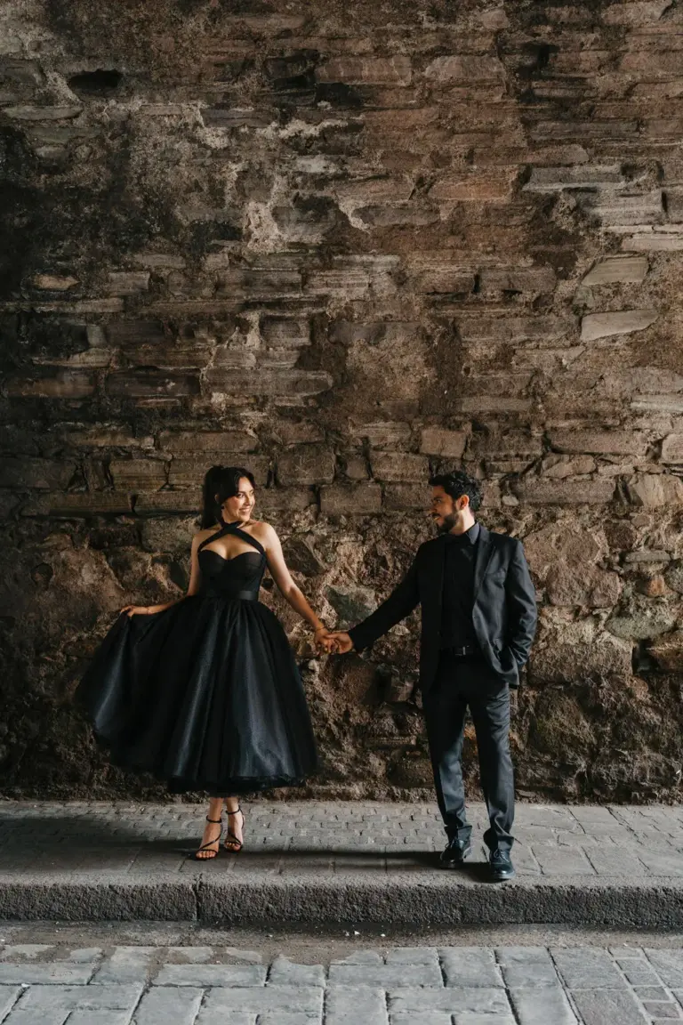 Guanajuato engagement black dress twirl stone wall