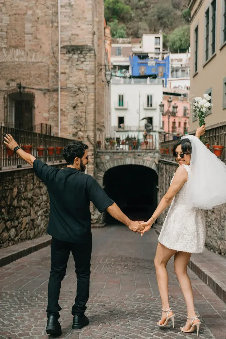 Guanajuato engagement playful arms out alley